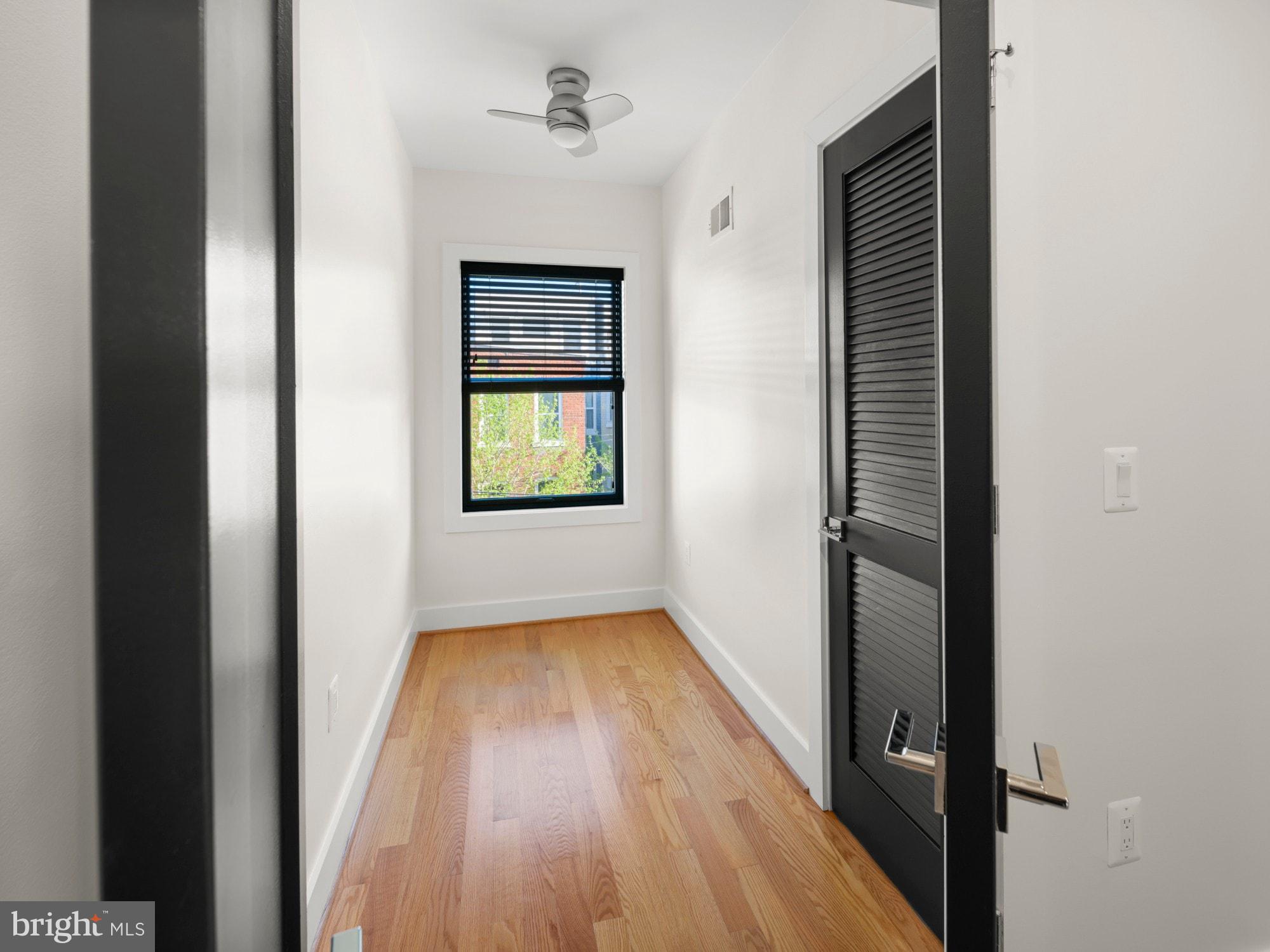 609 Gresham Place Northwest, Unit 2 Washington, DC 20001 - Photo 11 of 35 a view of a hallway with wooden floor and a bathroom