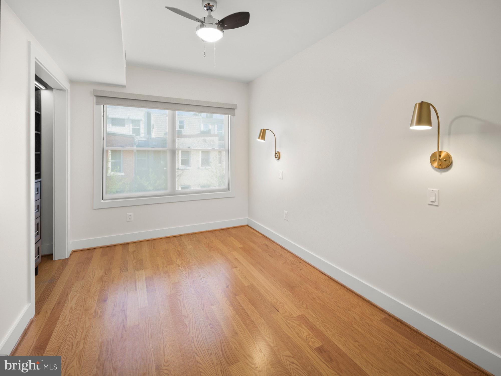 609 Gresham Place Northwest, Unit 2 Washington, DC 20001 - Photo 12 of 35 an empty room with wooden floor and windows