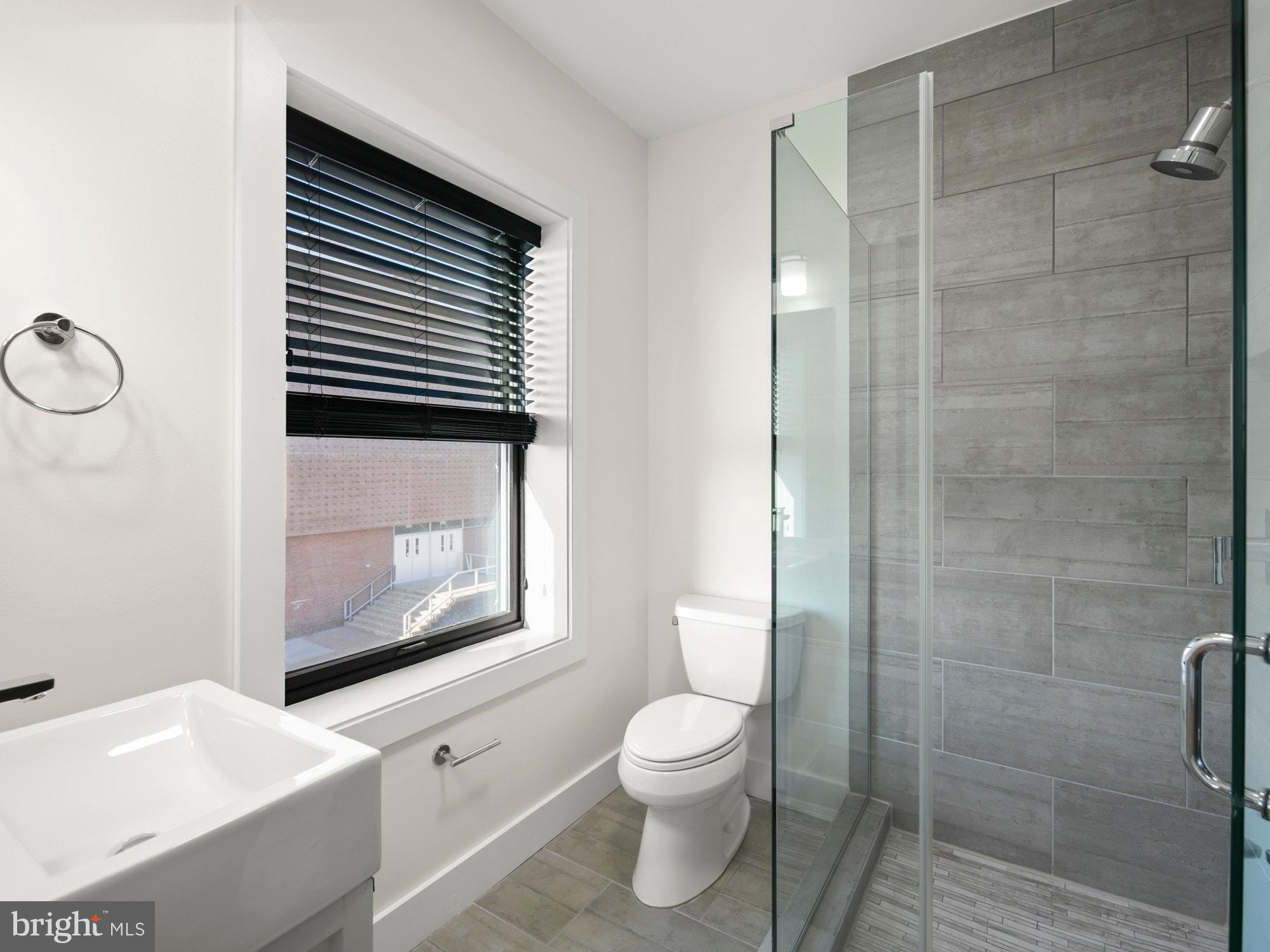 609 Gresham Place Northwest, Unit 2 Washington, DC 20001 - Photo 16 of 35 a bathroom with a toilet a sink and mirror