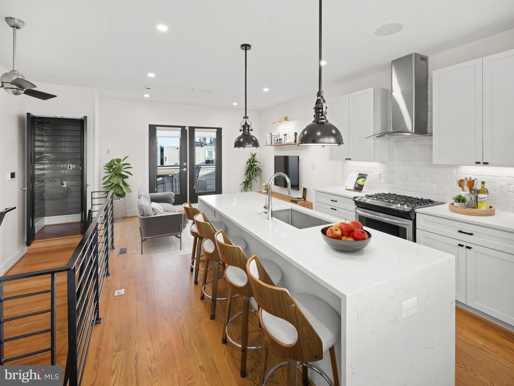 609 Gresham Place Northwest, Unit 2 Washington, DC 20001 - Photo 2 of 35 a kitchen with a sink a stove and chairs