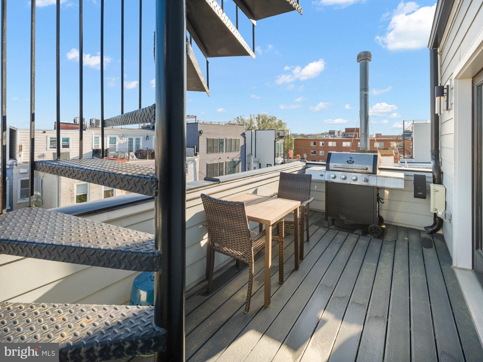 609 Gresham Place Northwest, Unit 2 Washington, DC 20001 - Photo 27 of 35 a balcony with wooden floor table and chairs