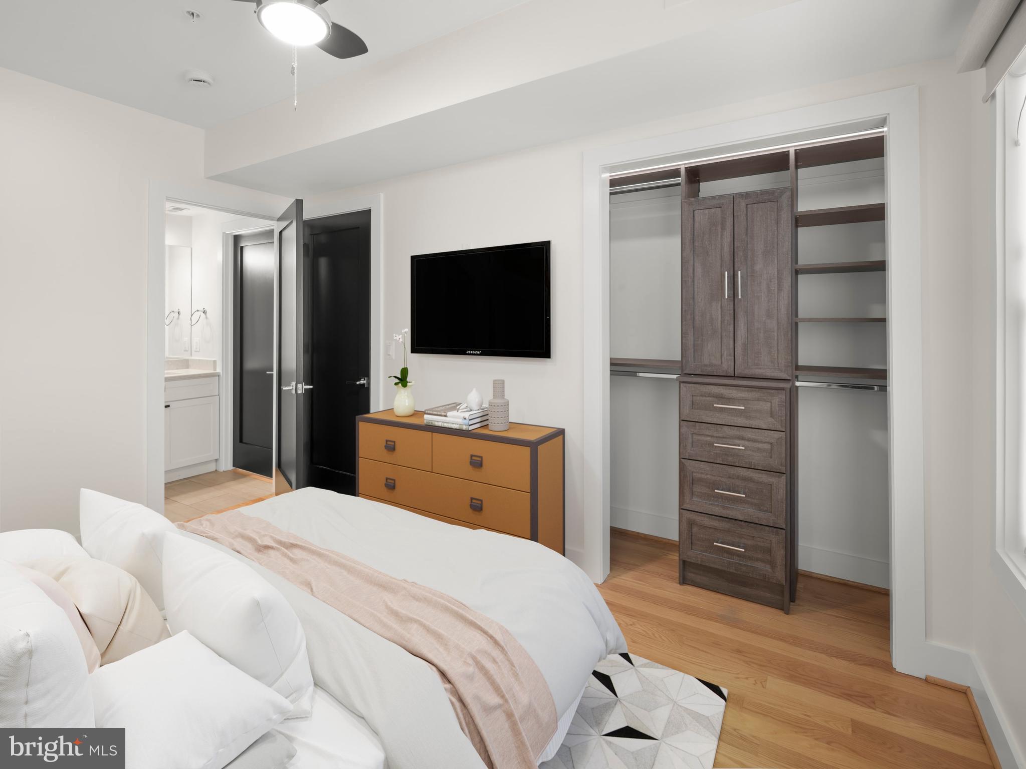 609 Gresham Place Northwest, Unit 2 Washington, DC 20001 - Photo 4 of 35 a bedroom with a bed and a flat screen tv