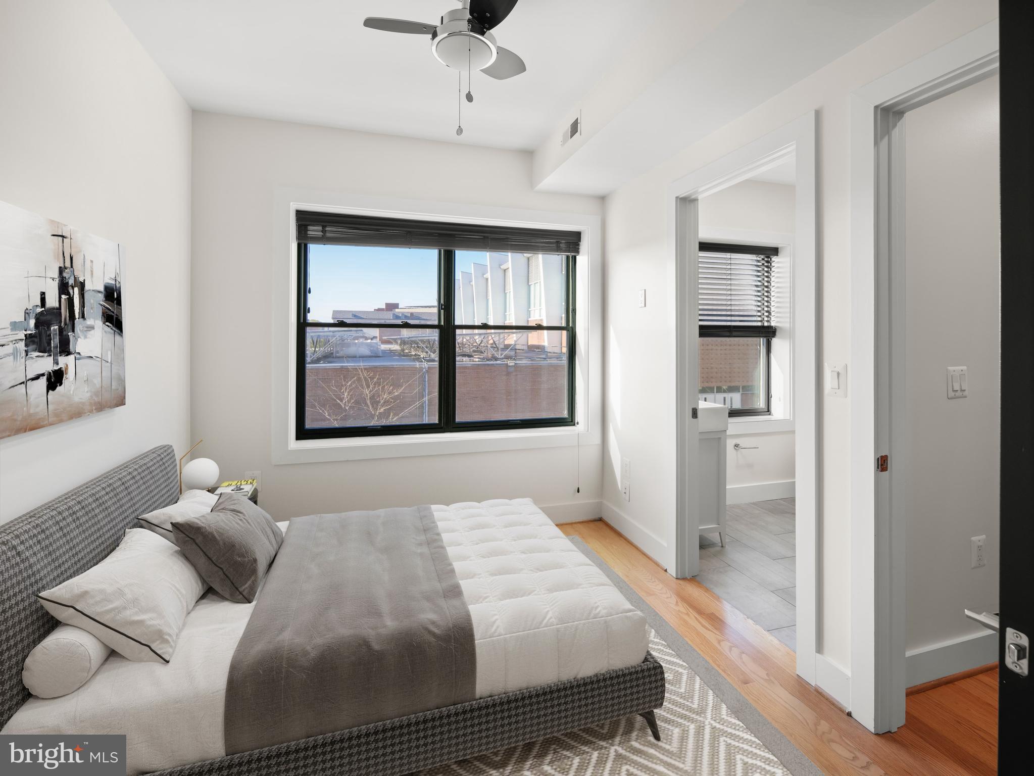 609 Gresham Place Northwest, Unit 2 Washington, DC 20001 - Photo 5 of 35 a bedroom with a bed and wooden floor