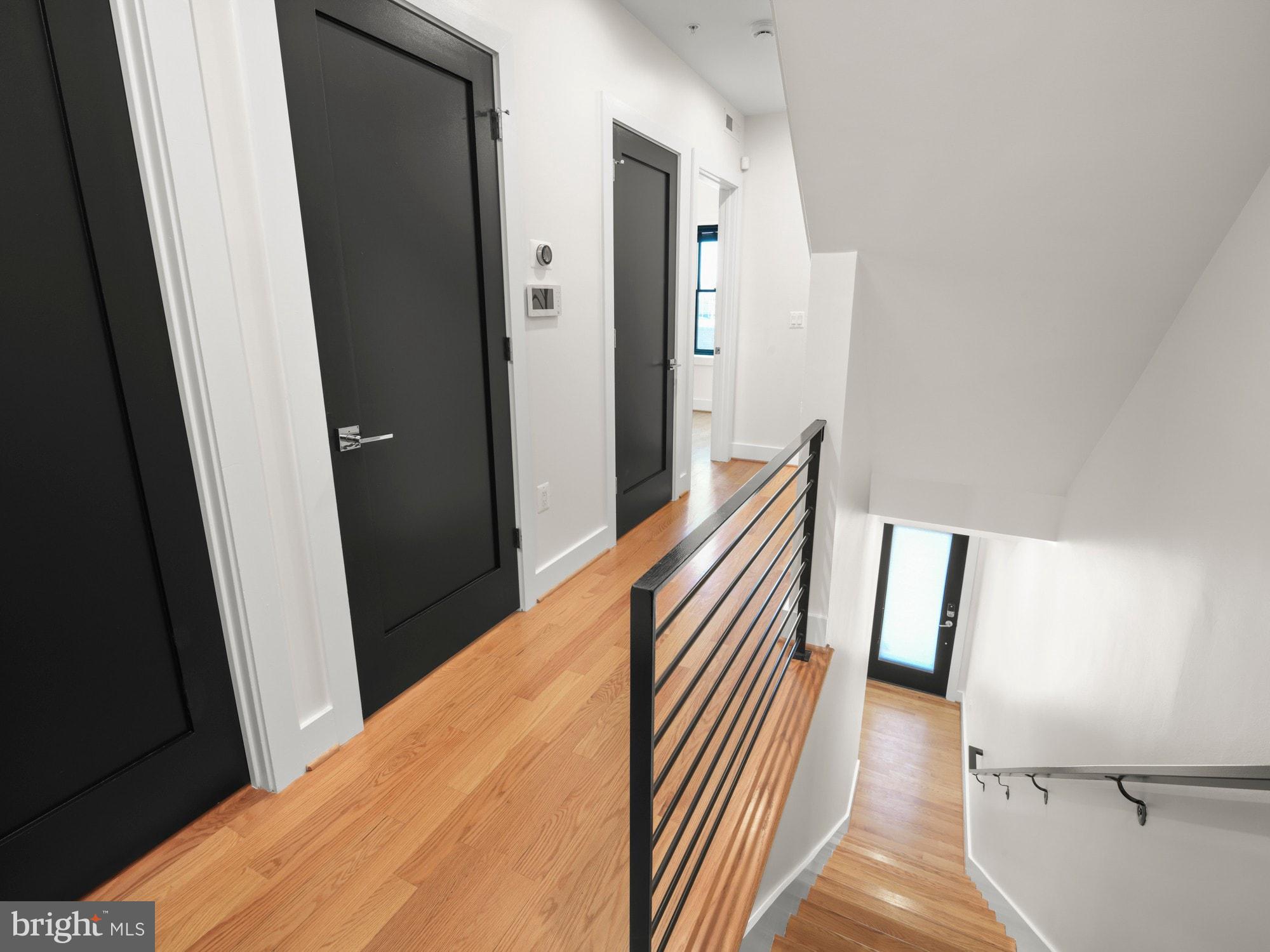 609 Gresham Place Northwest, Unit 2 Washington, DC 20001 - Photo 10 of 35 a view of a hallway with wooden floor and stairs