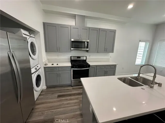a kitchen with a sink a washer and dryer