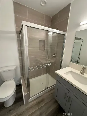 a bathroom with a granite countertop sink toilet and shower