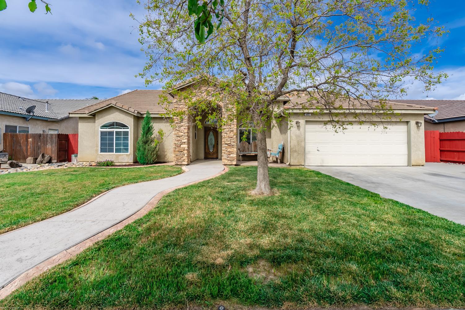 a front view of a house with a garden and yard