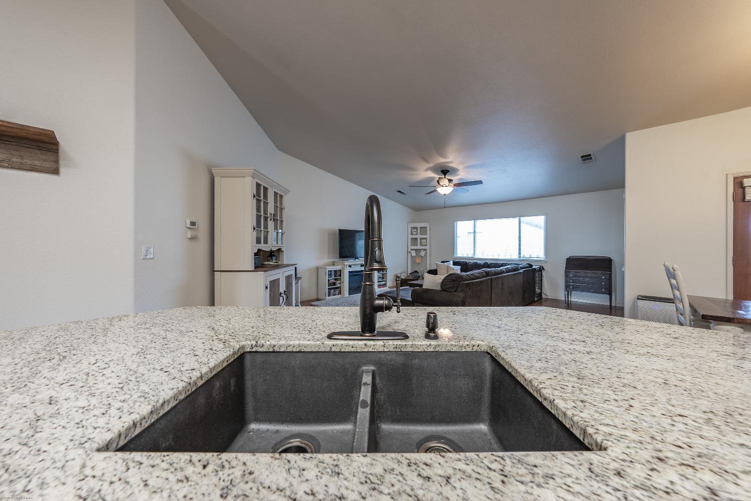 695 Crescent Lane Lemoore, CA 93245 - Photo 15 of 47 a kitchen with stainless steel appliances granite countertop a sink stove and refrigerator
