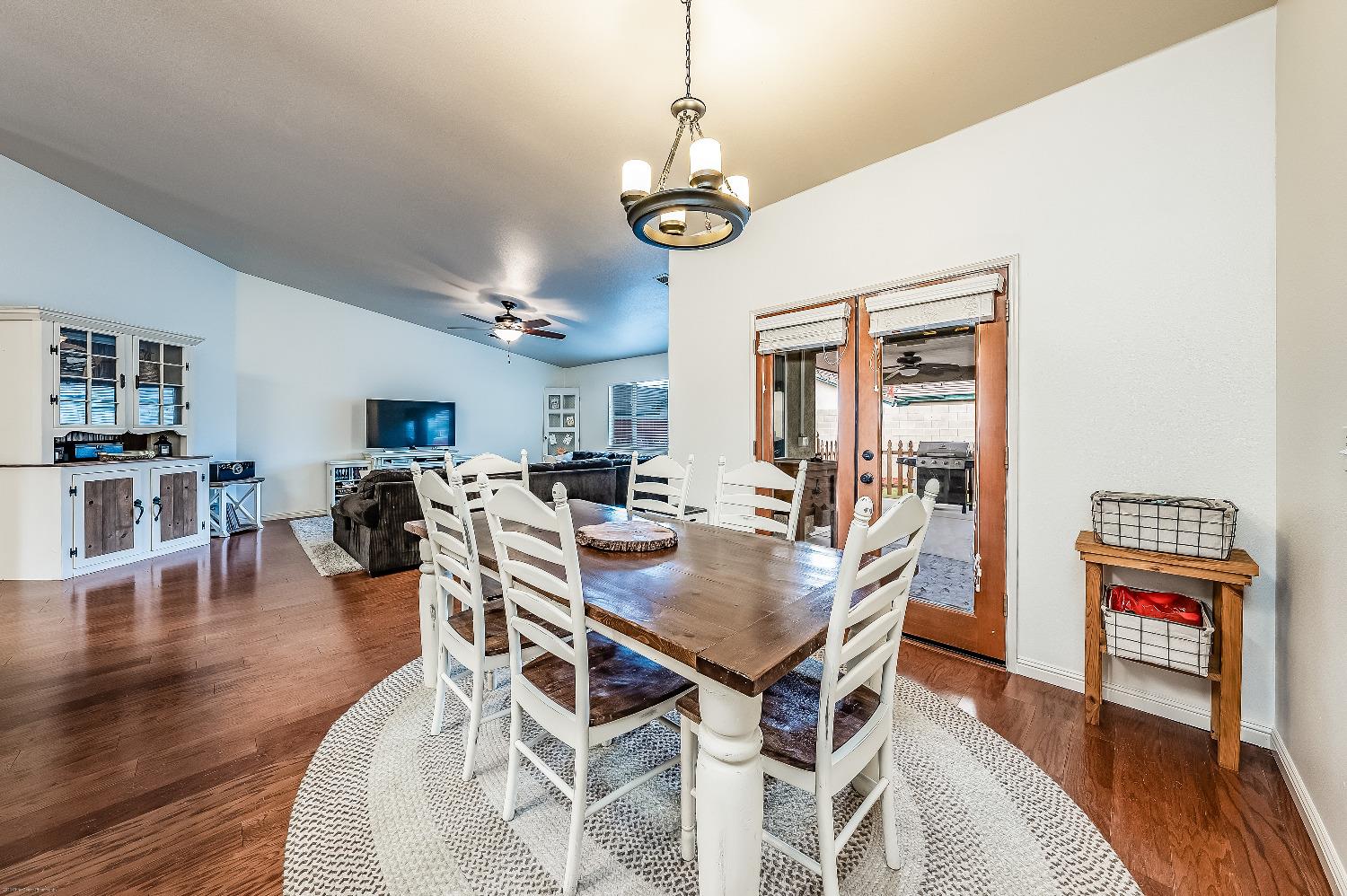 695 Crescent Lane Lemoore, CA 93245 - Photo 16 of 47 a view of a dining room with furniture and wooden floor