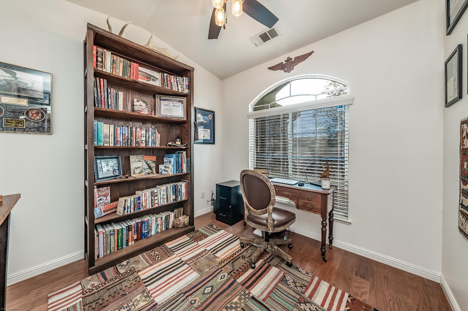 695 Crescent Lane Lemoore, CA 93245 - Photo 17 of 47 a living room with furniture a rug and a book shelf