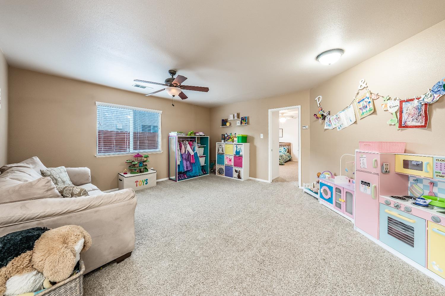 695 Crescent Lane Lemoore, CA 93245 - Photo 18 of 47 a living room with furniture and a baby crib