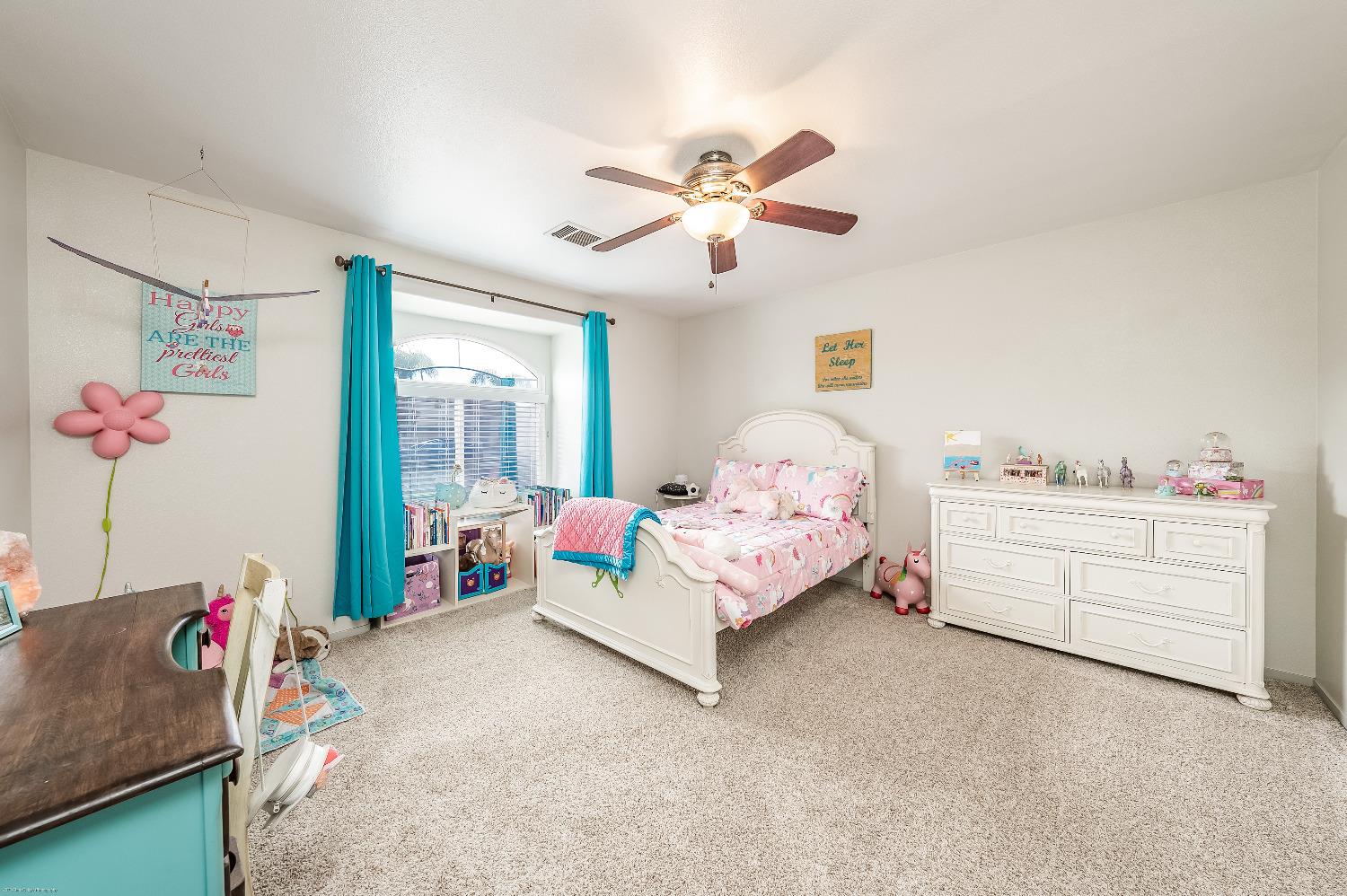 695 Crescent Lane Lemoore, CA 93245 - Photo 21 of 47 a bedroom with a bed and window