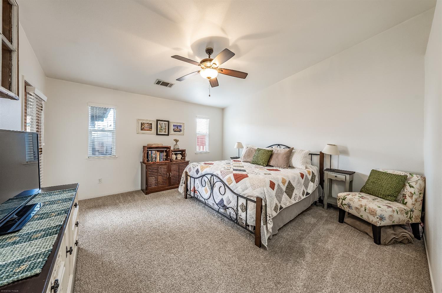 695 Crescent Lane Lemoore, CA 93245 - Photo 22 of 47 a spacious bedroom with a bed and a couch