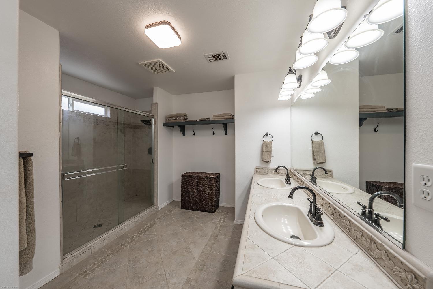 695 Crescent Lane Lemoore, CA 93245 - Photo 24 of 47 a bathroom with a sink and a mirror