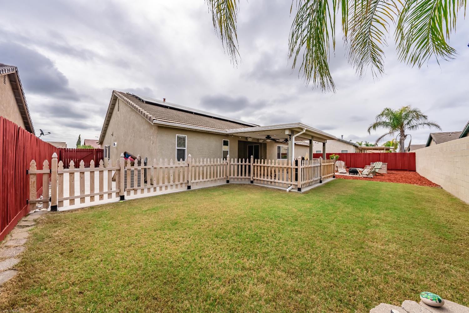 695 Crescent Lane Lemoore, CA 93245 - Photo 35 of 47 a view of a house with a yard and deck