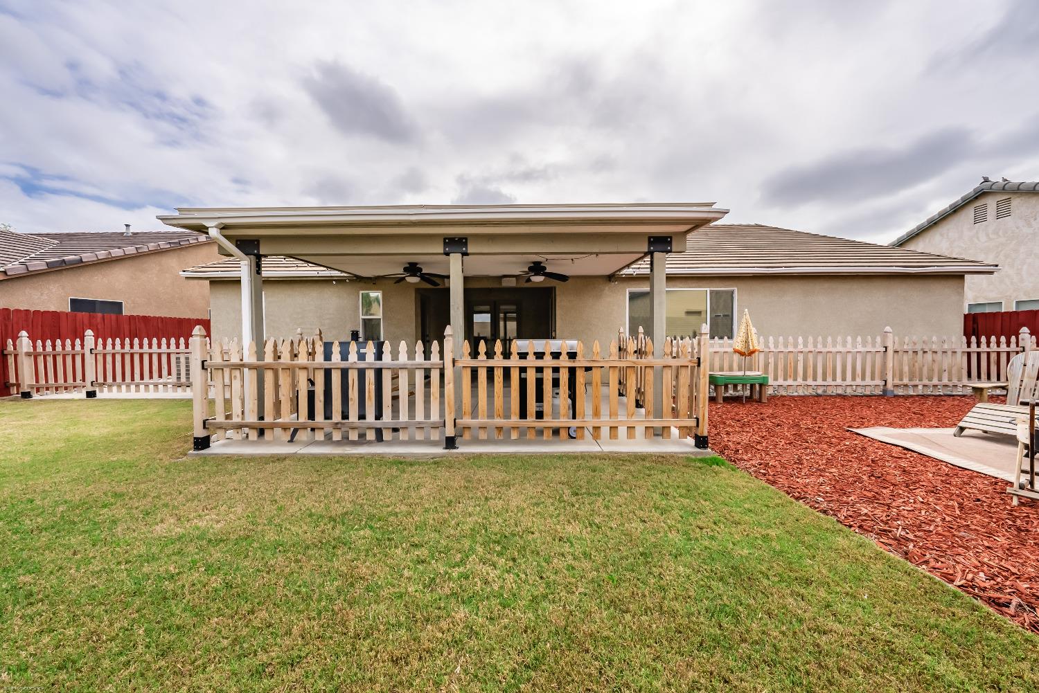 695 Crescent Lane Lemoore, CA 93245 - Photo 36 of 47 a porch with a table in front of it
