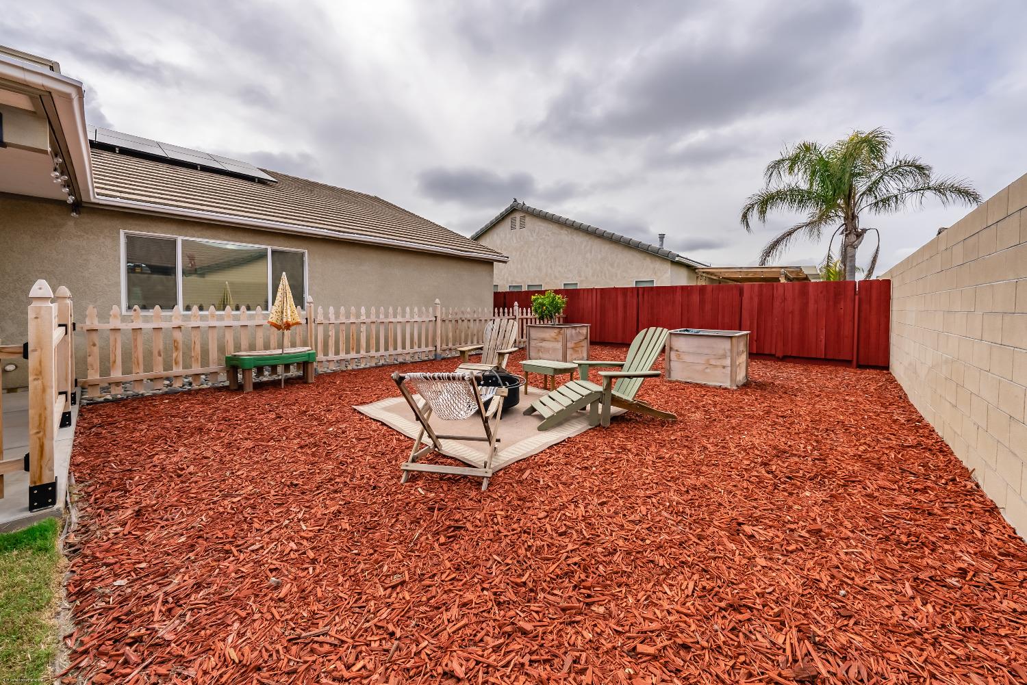 695 Crescent Lane Lemoore, CA 93245 - Photo 37 of 47 a view of a backyard with a patio and a garden