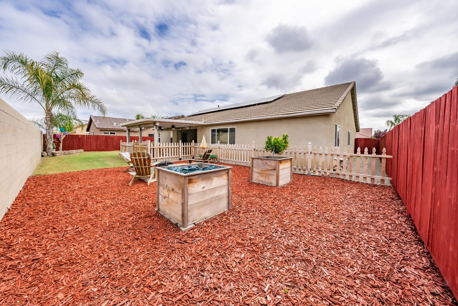 695 Crescent Lane Lemoore, CA 93245 - Photo 38 of 47 a living room with patio furniture and a garden