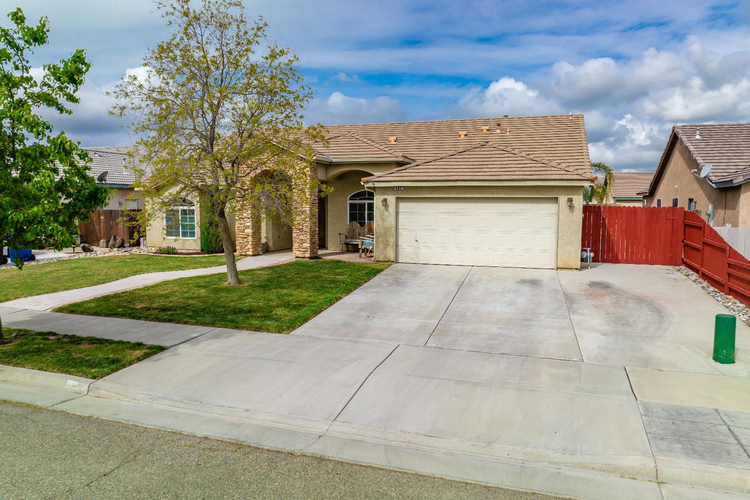695 Crescent Lane Lemoore, CA 93245 - Photo 39 of 47 a front view of a house with a yard and garage