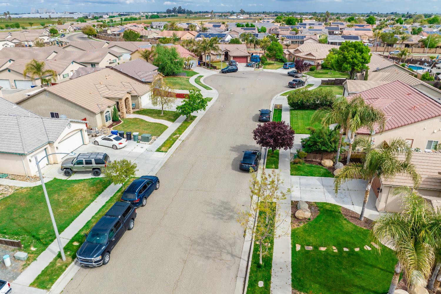695 Crescent Lane Lemoore, CA 93245 - Photo 45 of 47 an aerial view of a house with a garden and lake view