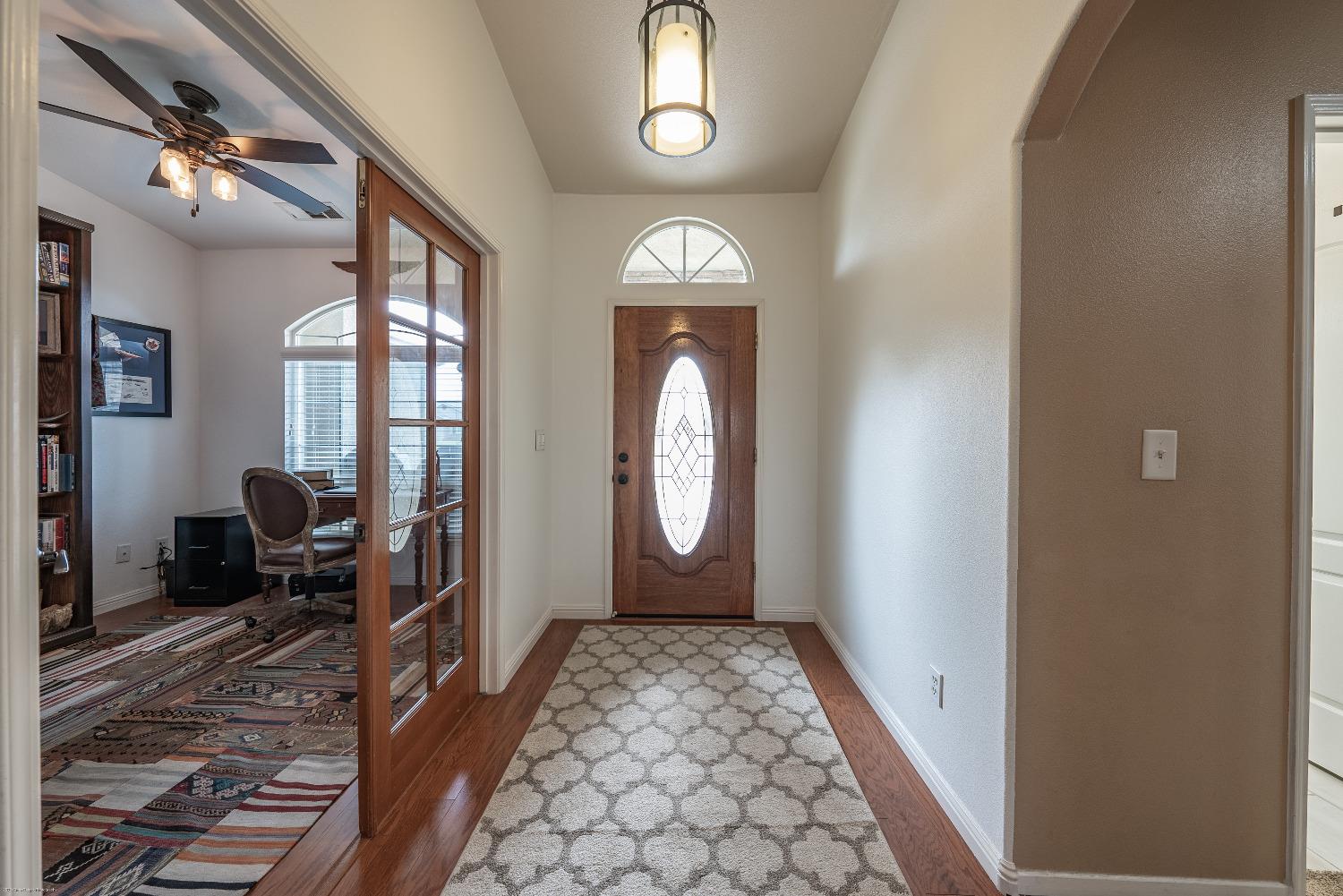 695 Crescent Lane Lemoore, CA 93245 - Photo 5 of 47 a view of a hallway with wooden floor windows and a bathroom