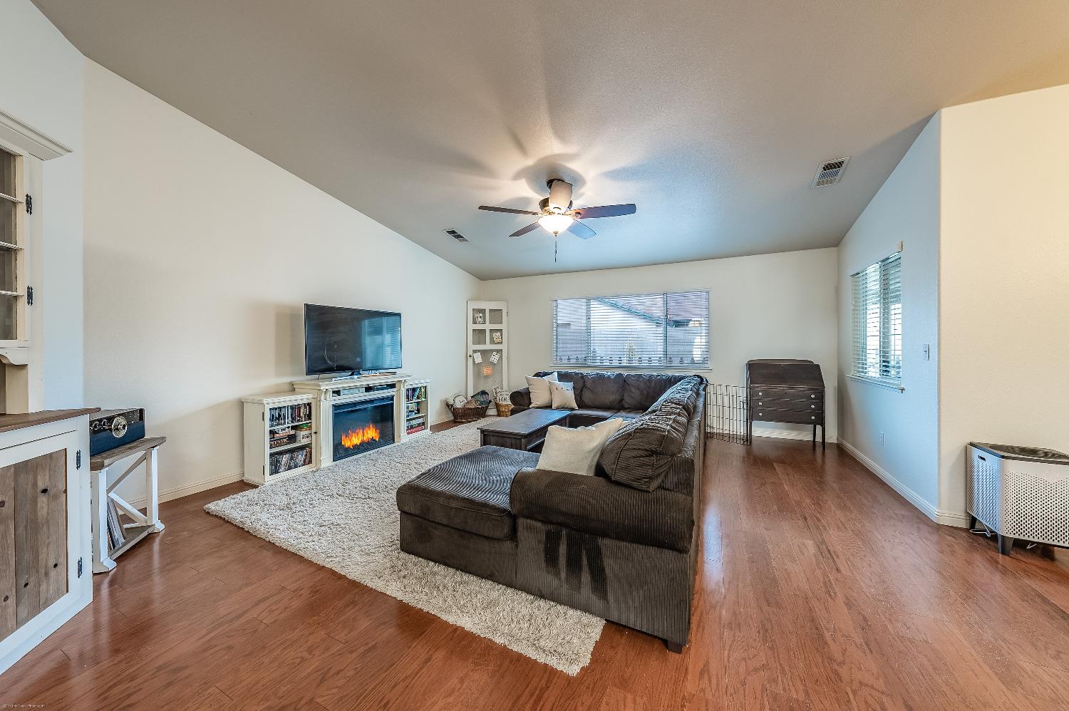 695 Crescent Lane Lemoore, CA 93245 - Photo 6 of 47 a living room with furniture and a flat screen tv