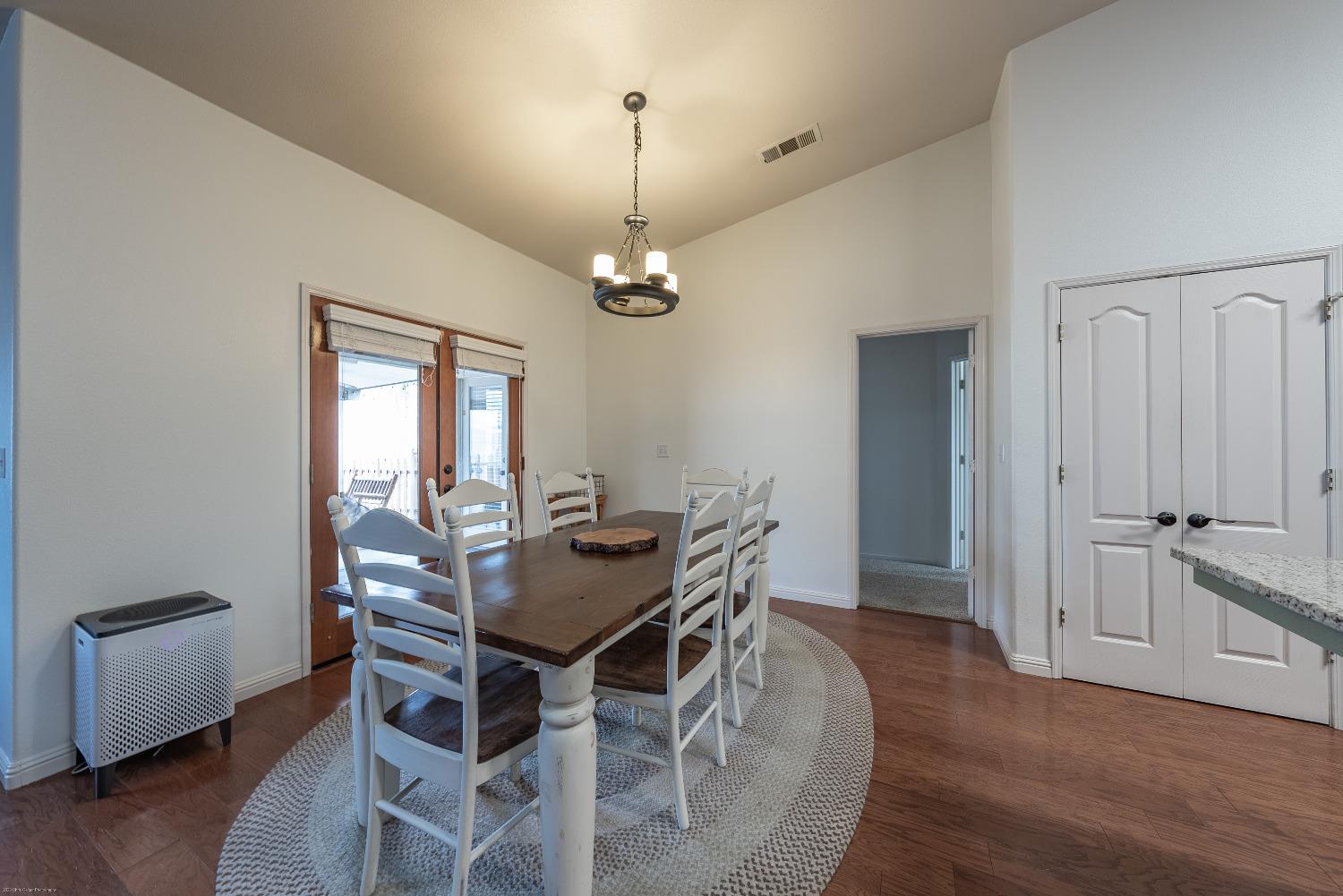 695 Crescent Lane Lemoore, CA 93245 - Photo 8 of 47 a dining room with furniture a chandelier and wooden floor