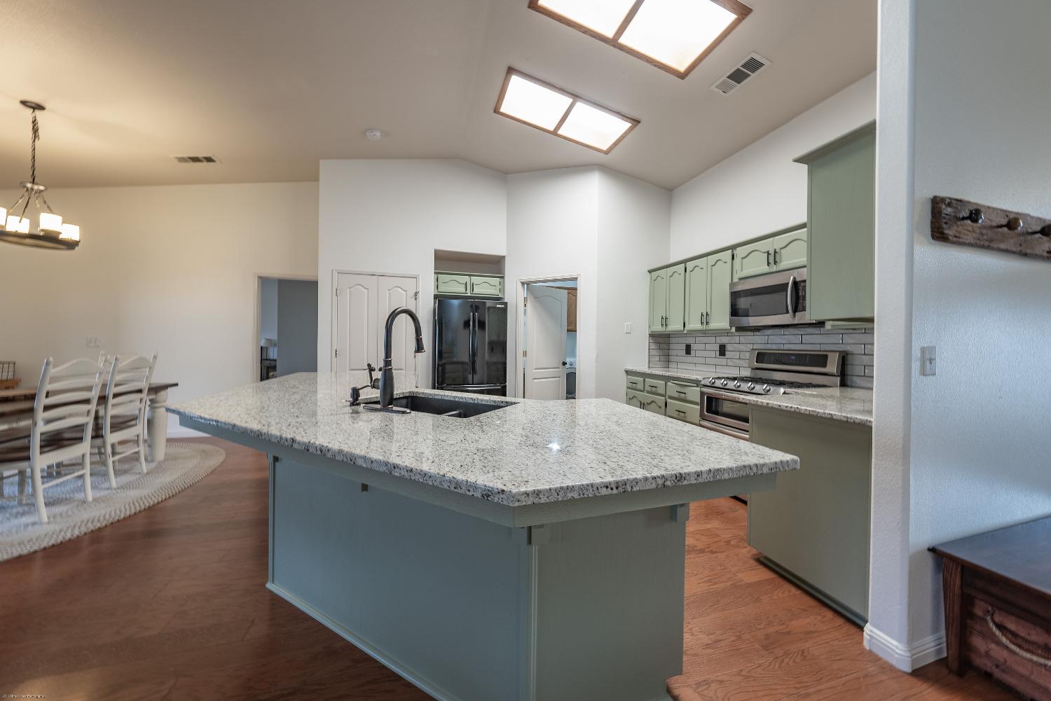 695 Crescent Lane Lemoore, CA 93245 - Photo 10 of 47 a kitchen with stainless steel appliances granite countertop a sink stove and refrigerator