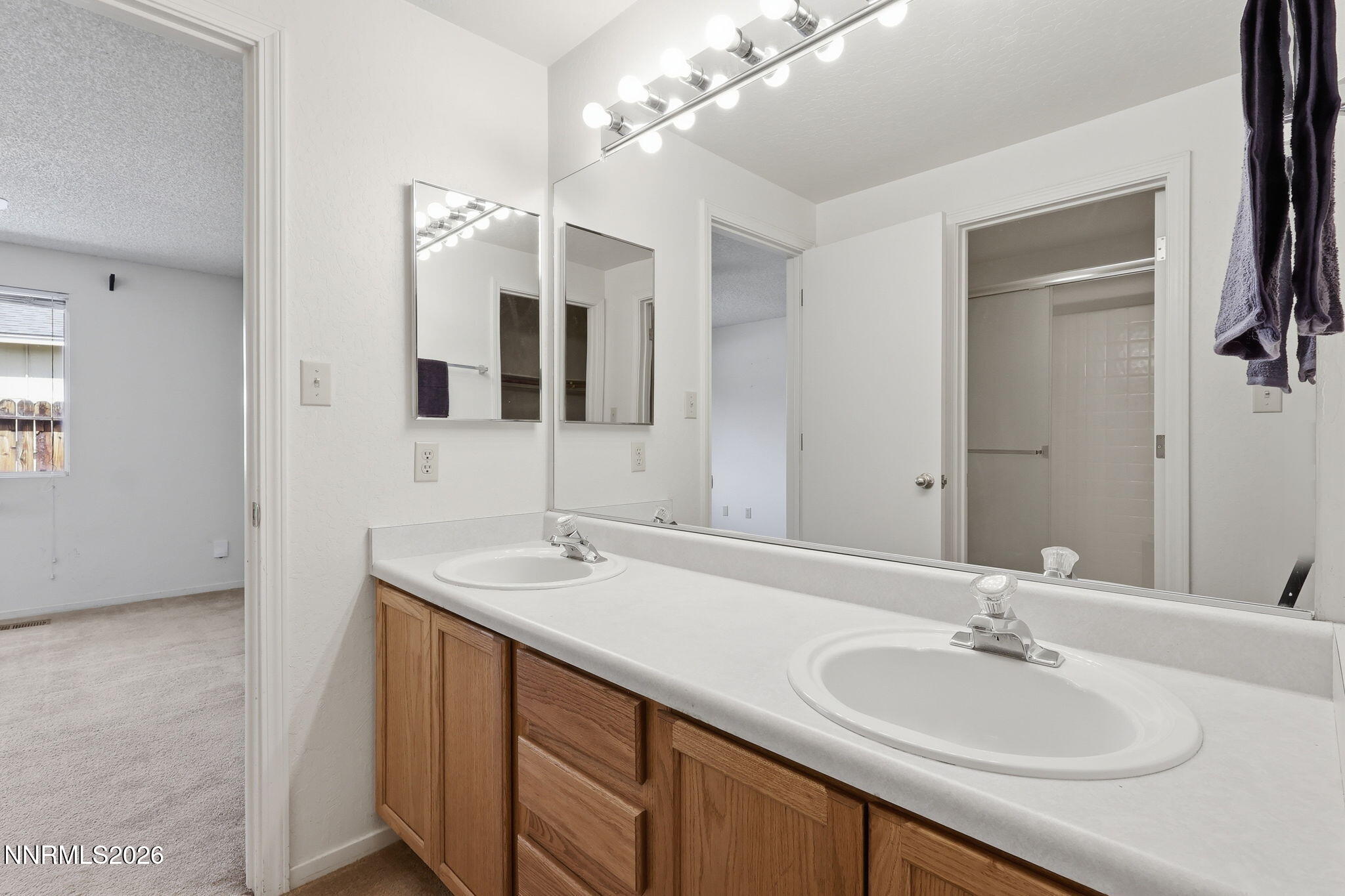 6840 Viscaya Court Reno, NV 89523 - Photo 23 of 25 a bathroom with a sink and a mirror
