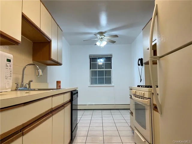 a kitchen with a sink appliances and cabinets