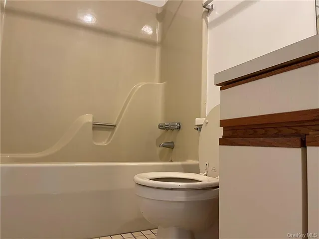 a bathroom with a sink a toilet a shower and a mirror