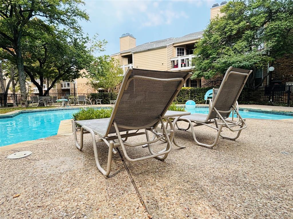 14277 Preston Road, Unit 416 Dallas, TX 75254 - Photo 9 of 40 Community swimming pool with a concrete deck, surrounded by mature trees and residential buildings