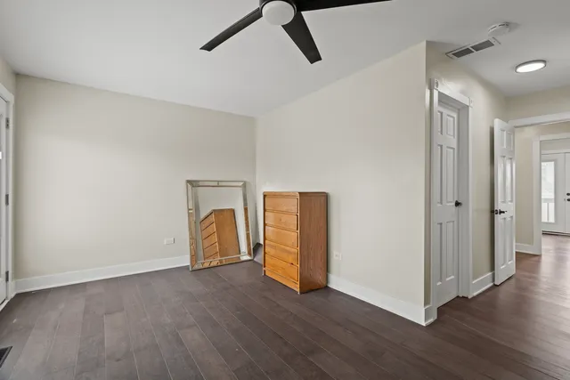 a view of a livingroom with wooden floor and a ceiling fan