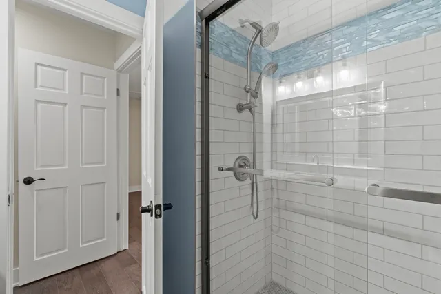 a bathroom with a glass shower door