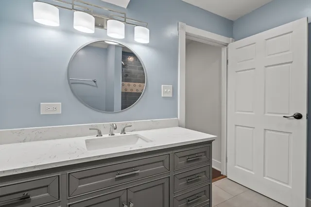 a bathroom with a sink a vanity and a mirror