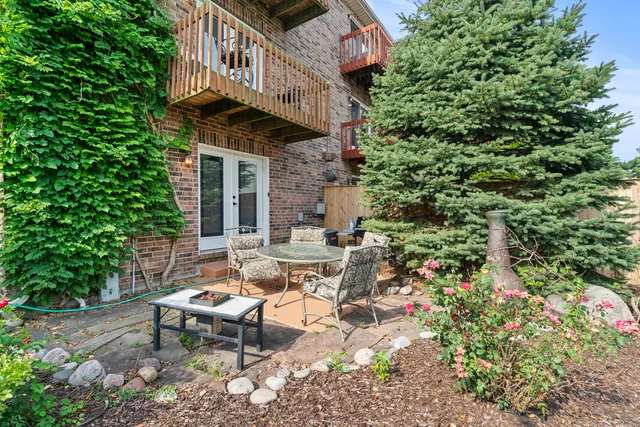 a view of a patio with table and chairs and potted plants