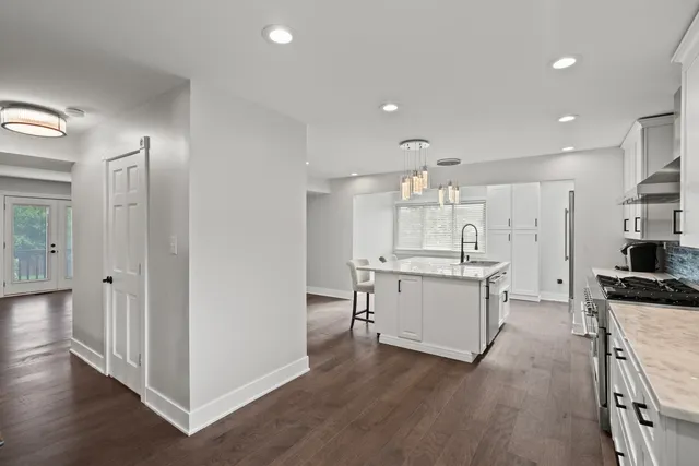 a large kitchen with a table and chairs in it