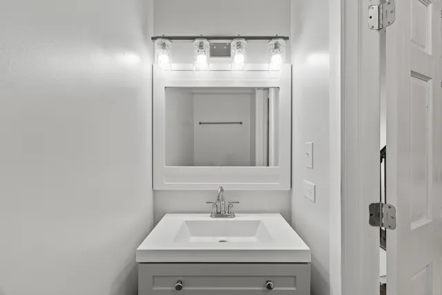 a bathroom with a sink and a mirror