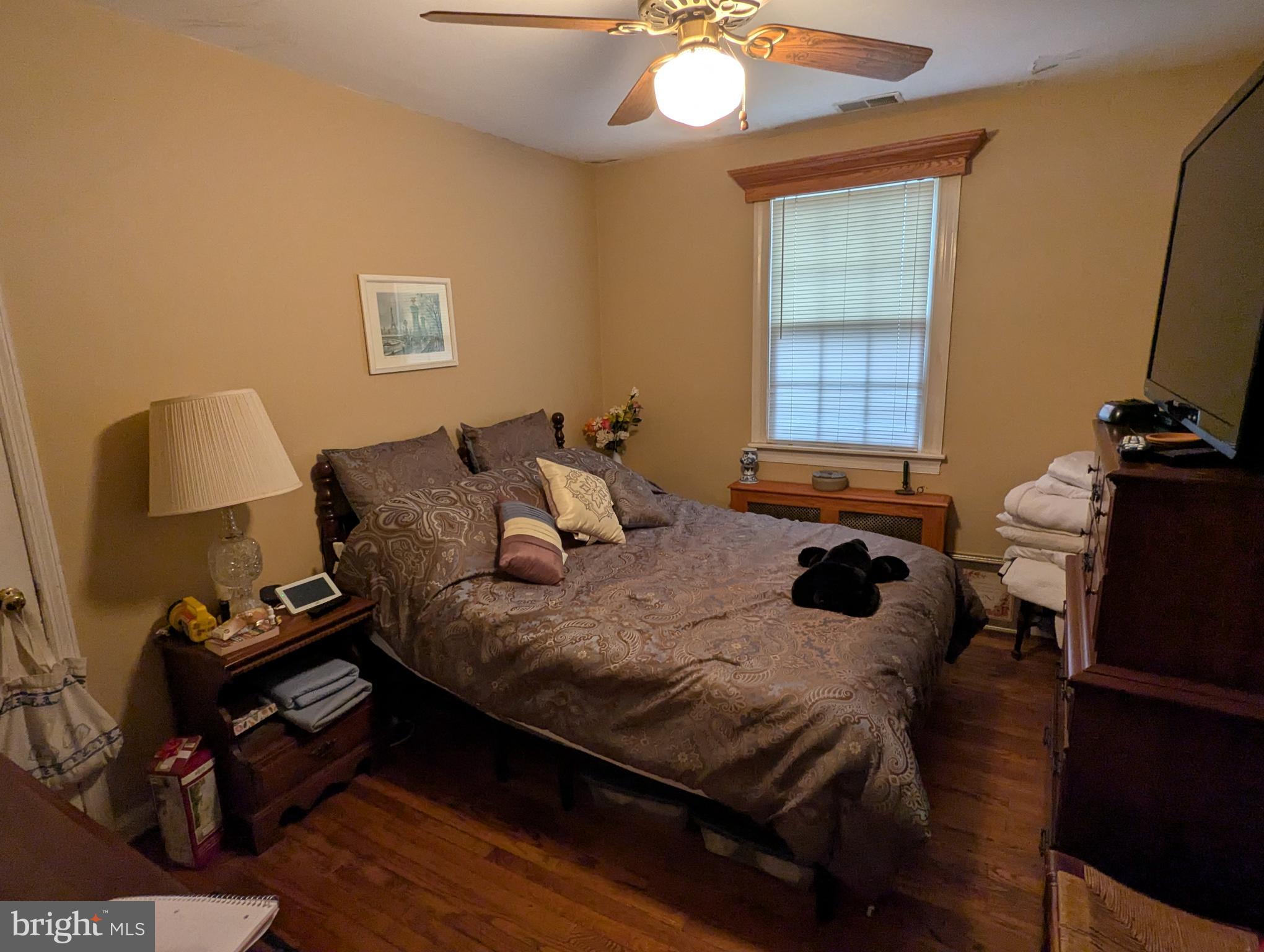 1475 Woodstock Road Woodstock, MD 21163 - Photo 16 of 26 a bedroom with a bed and wooden floor