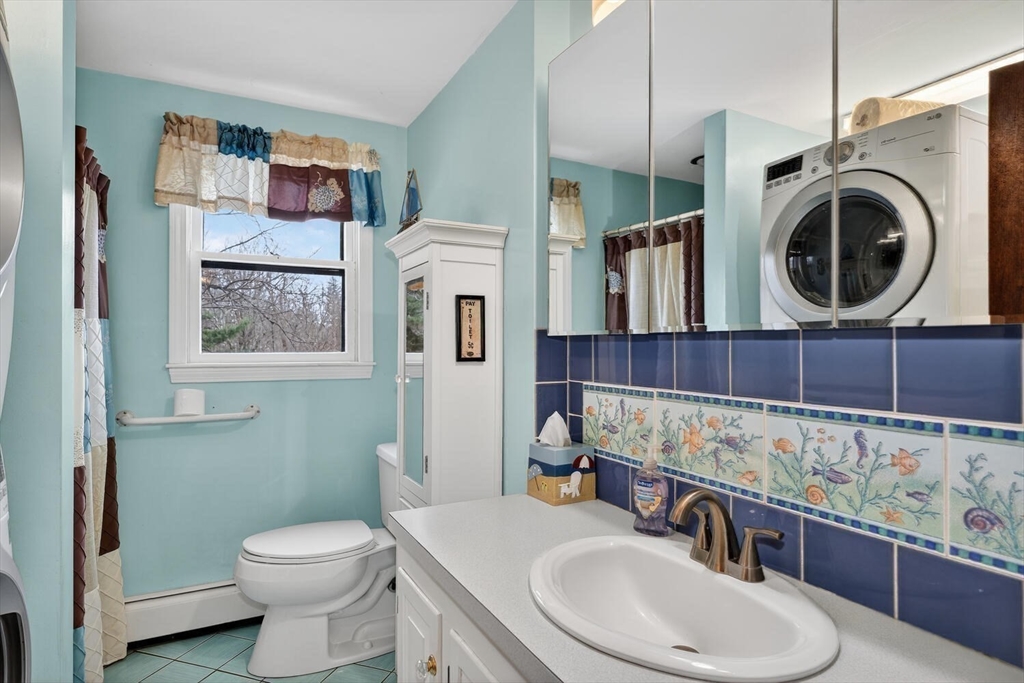 15 Rocky Pond Road Boylston, MA 01505 - Photo 25 of 39 a bathroom with a sink a toilet and a mirror