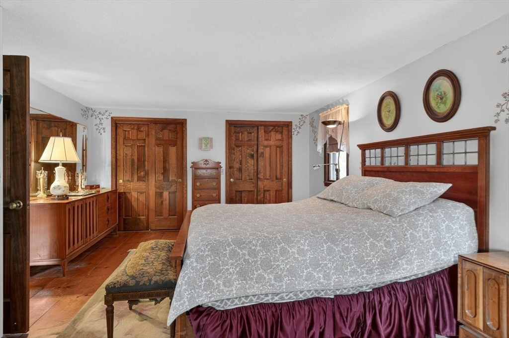 15 Rocky Pond Road Boylston, MA 01505 - Photo 28 of 39 a bedroom with a bed and dresser with mirror