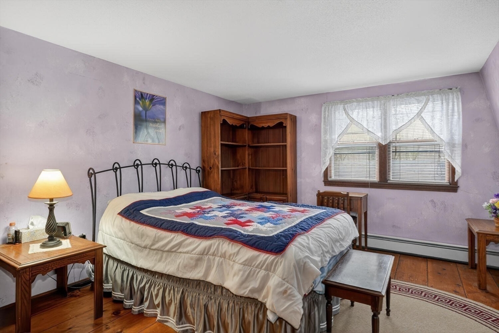 15 Rocky Pond Road Boylston, MA 01505 - Photo 29 of 39 a bedroom with a bed a dresser and a window