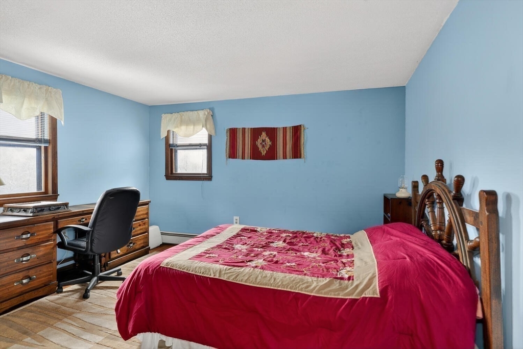 15 Rocky Pond Road Boylston, MA 01505 - Photo 30 of 39 a bedroom with a bed and a chair