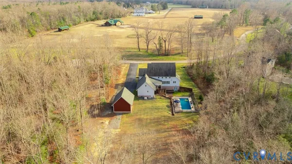 a kitchen with stainless steel appliances granite countertop a table chairs refrigerator and sink
