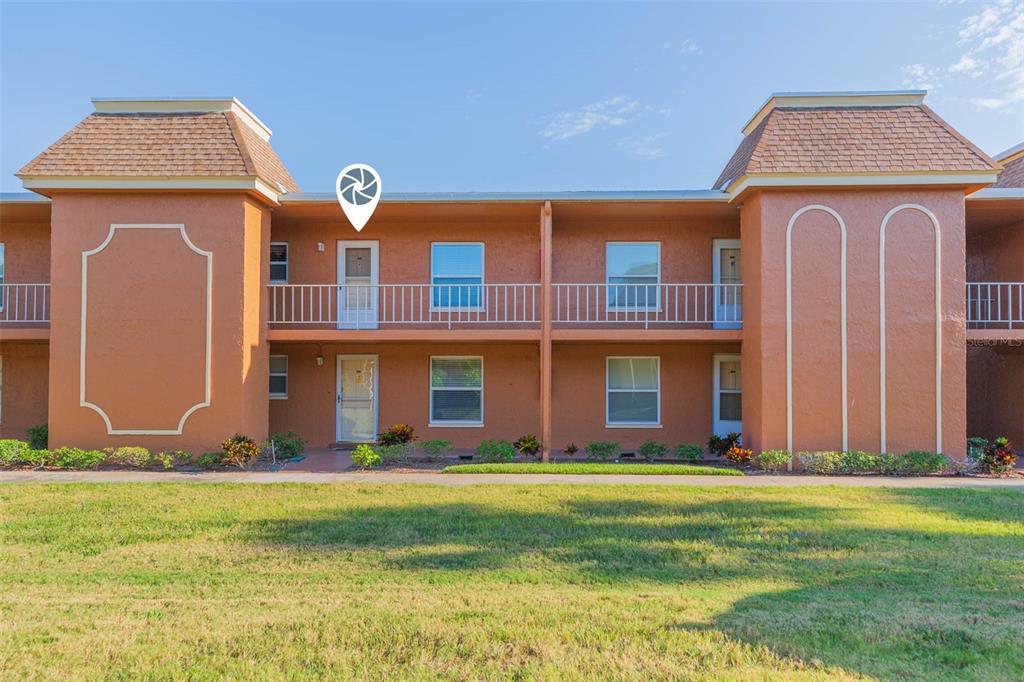 12760 Indian Rocks Road, Unit 909 Largo, FL 33774 - Photo 1 of 1 a front view of a house with a yard