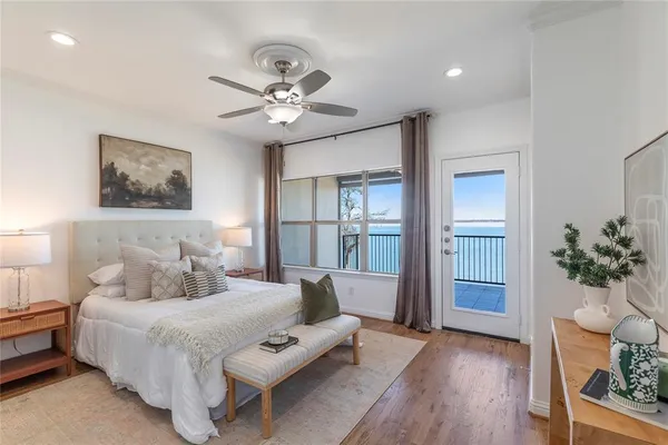 a bedroom with a large bed and a chandelier