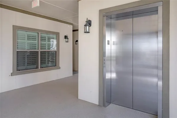 an aerial view of a house with a yard and lake view