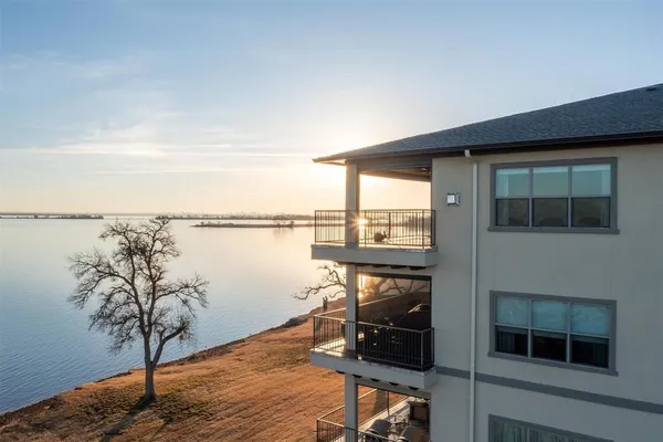 an aerial view of a house with outdoor space and lake view