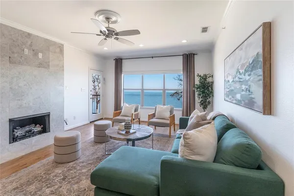a living room with furniture and a view of kitchen