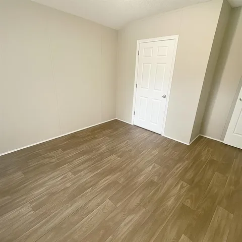 an empty room with wooden floor